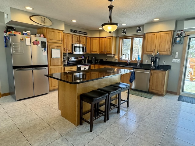 kitchen featuring recessed lighting, a wealth of natural light, stainless steel appliances, and a sink