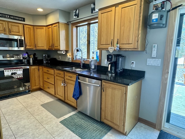 kitchen featuring brown cabinets, a healthy amount of sunlight, stainless steel appliances, and a sink