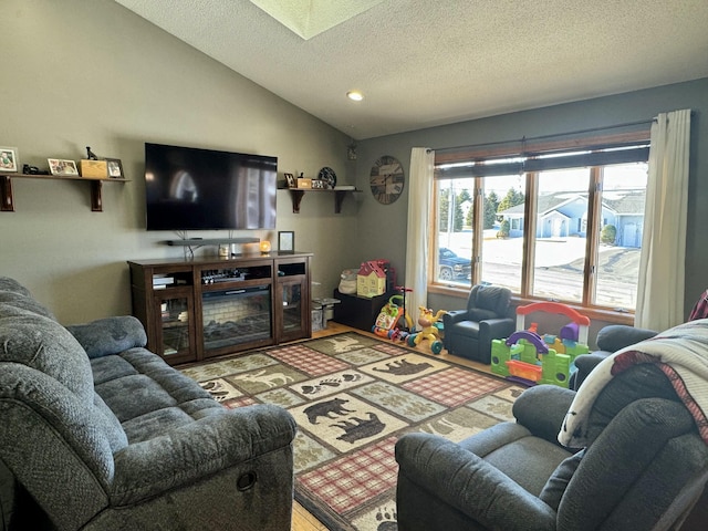 living room with vaulted ceiling with skylight, a textured ceiling, and recessed lighting