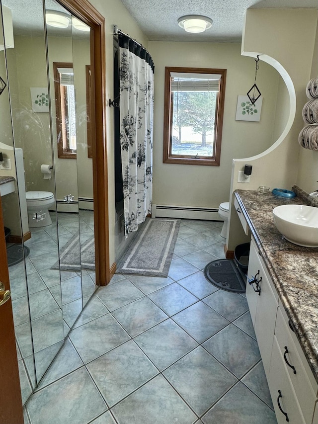 bathroom featuring toilet, vanity, a shower with shower curtain, a baseboard radiator, and a textured ceiling