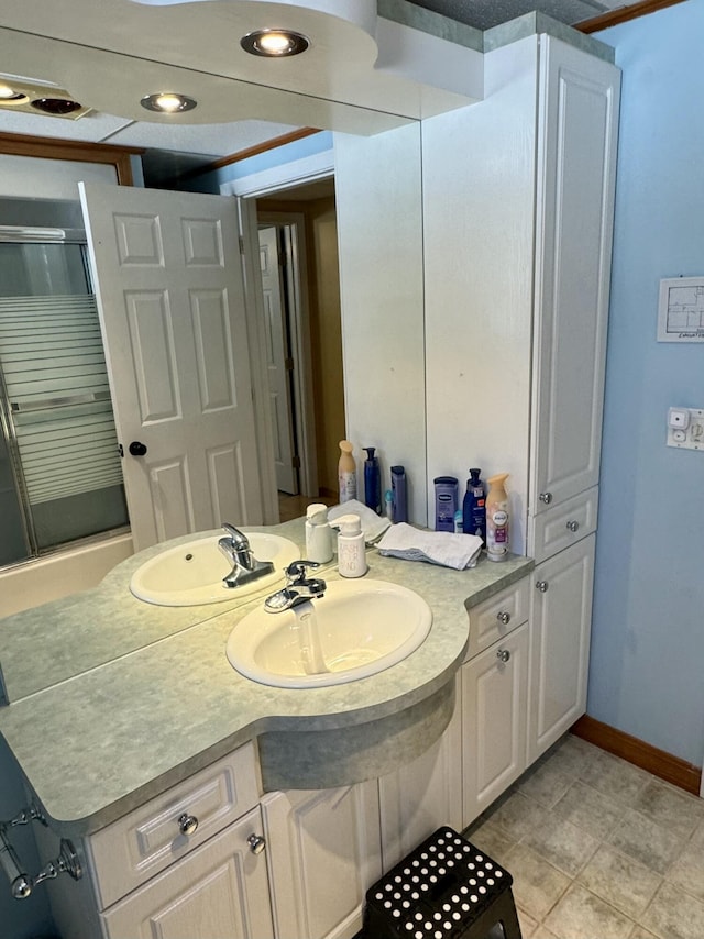 bathroom featuring baseboards, an enclosed shower, vanity, and recessed lighting