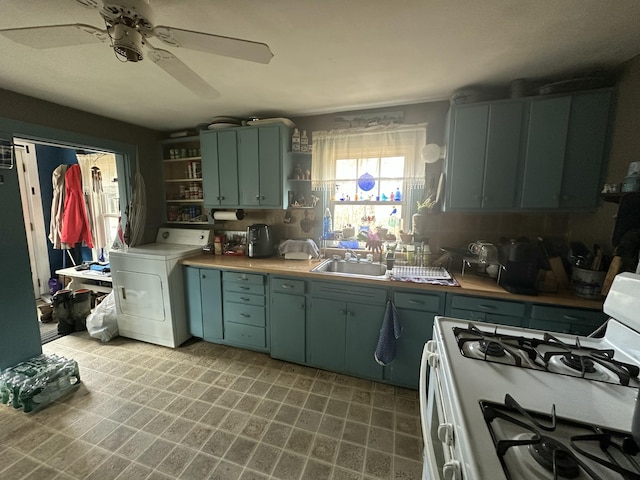 18 View St, Jonesport, ME 04649 - kitchen featuring washer / dryer, gas range gas stove, open shelves, a sink, and green cabinets