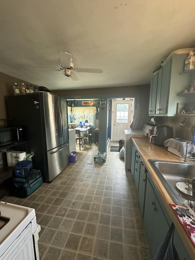 18 View St, Jonesport, ME 04649 - kitchen featuring black microwave, ceiling fan, washer / clothes dryer, a sink, and dark floors