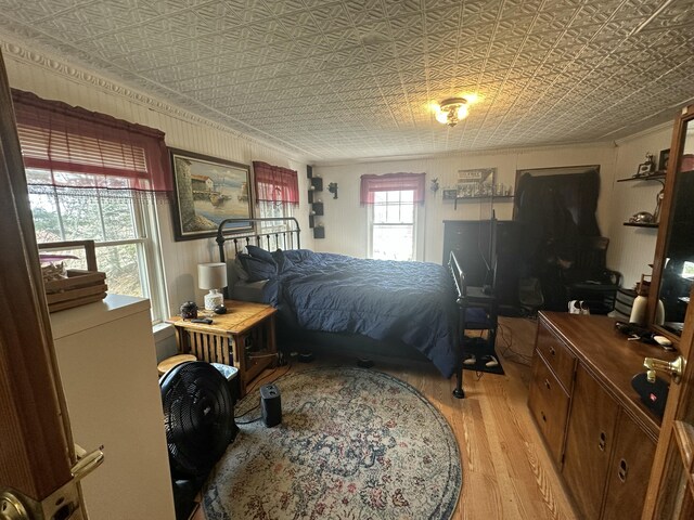 18 View St, Jonesport, ME 04649 - bedroom featuring light wood-style flooring, an ornate ceiling, ornamental molding, and an office area