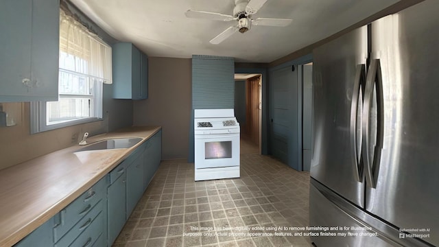 18 View St, Jonesport, ME 04649 - kitchen with freestanding refrigerator, white range with gas cooktop, blue cabinets, ceiling fan, and a sink