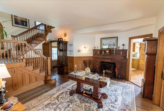 36 Cutler Rd, East Machias, ME 04630 - living room with wood finished floors, wainscoting, a fireplace, and stairway