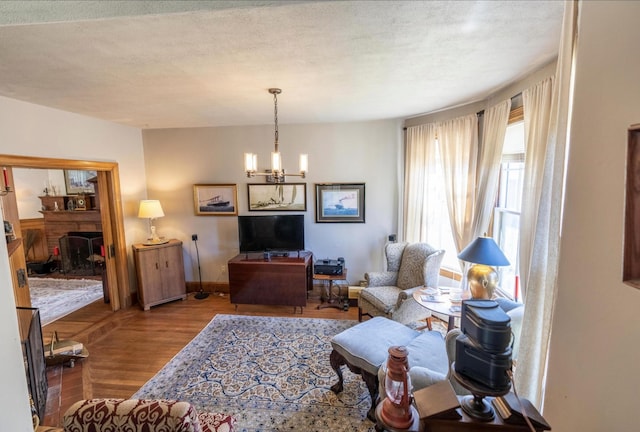 36 Cutler Rd, East Machias, ME 04630 - living room featuring a chandelier, wood finished floors, and baseboards