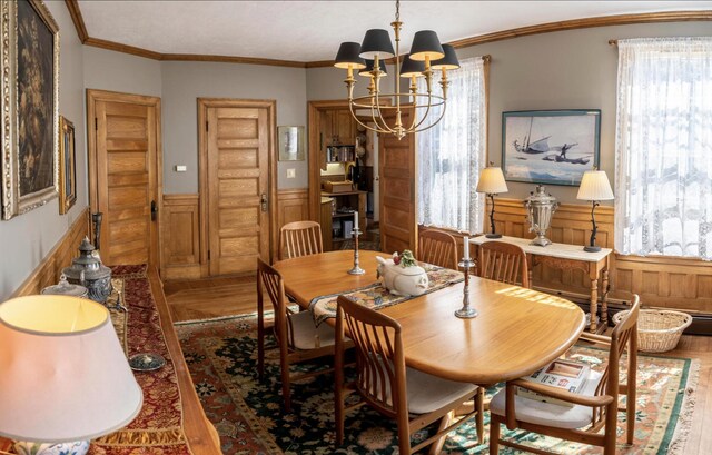 36 Cutler Rd, East Machias, ME 04630 - dining area with wood finished floors, wainscoting, a chandelier, healthy amount of natural light, and ornamental molding