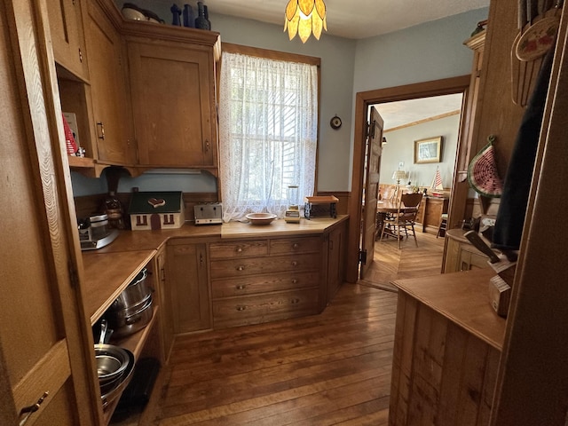 36 Cutler Rd, East Machias, ME 04630 - kitchen with a wainscoted wall, dark wood-type flooring, light countertops, and brown cabinetry