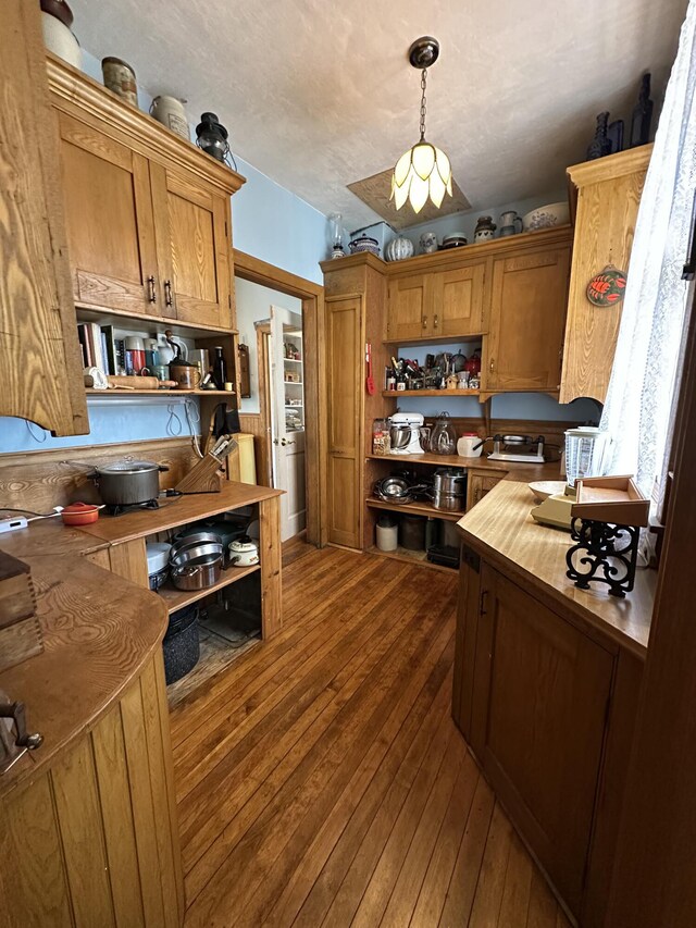 36 Cutler Rd, East Machias, ME 04630 - kitchen with open shelves, dark wood-type flooring, decorative light fixtures, and brown cabinetry