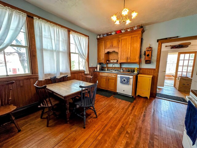 36 Cutler Rd, East Machias, ME 04630 - dining area featuring dark wood-type flooring, a chandelier, a wainscoted wall, plenty of natural light, and wood walls