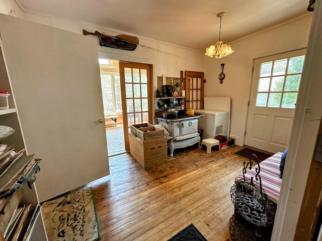 36 Cutler Rd, East Machias, ME 04630 - doorway with hardwood / wood-style floors, a chandelier, and crown molding