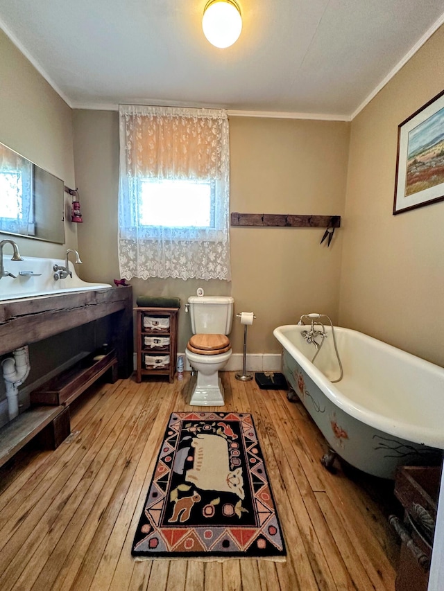 36 Cutler Rd, East Machias, ME 04630 - full bathroom with hardwood / wood-style floors, vanity, a freestanding bath, toilet, and crown molding