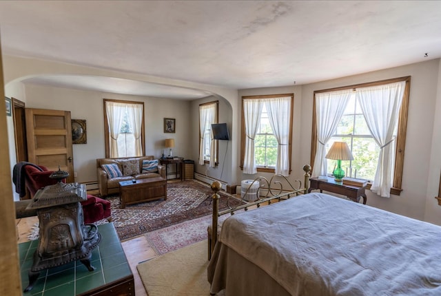 36 Cutler Rd, East Machias, ME 04630 - bedroom featuring arched walkways, wood finished floors, and baseboard heating