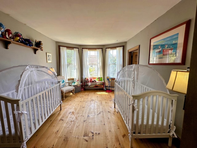 36 Cutler Rd, East Machias, ME 04630 - bedroom with wood-type flooring, multiple windows, and a baseboard heating unit