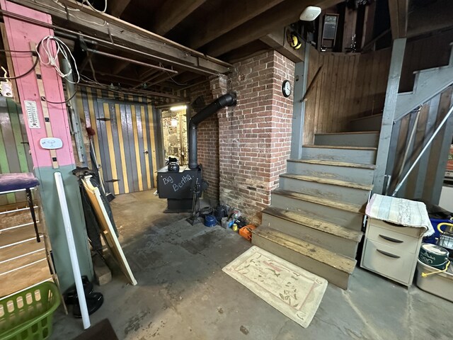 36 Cutler Rd, East Machias, ME 04630 - unfinished basement featuring stairway and a wood stove