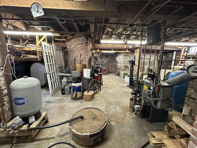 36 Cutler Rd, East Machias, ME 04630 - unfinished basement featuring brick wall and a heating unit