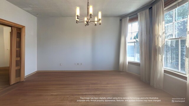 36 Cutler Rd, East Machias, ME 04630 - empty room with a chandelier, wood finished floors, and baseboards