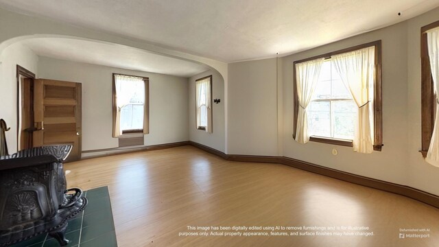 36 Cutler Rd, East Machias, ME 04630 - unfurnished living room with arched walkways, wood finished floors, and baseboards