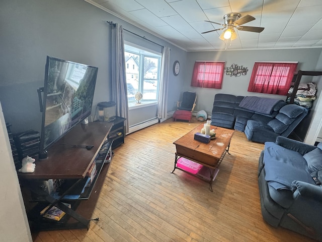 living room with crown molding, a baseboard radiator, ceiling fan, and wood-type flooring