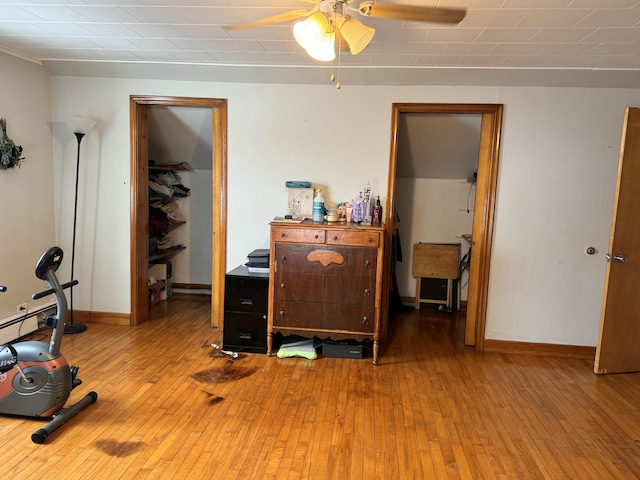 bedroom with hardwood / wood-style floors and baseboards