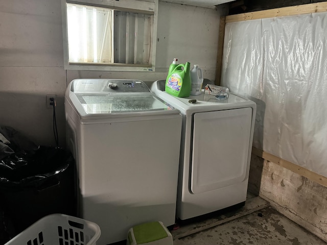 laundry room featuring separate washer and dryer and laundry area