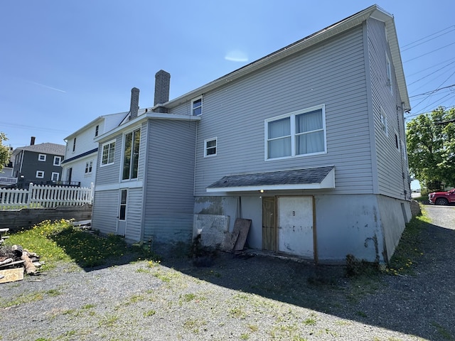 362 Saint Thomas St, Madawaska, ME 04756 - rear view of house featuring a chimney