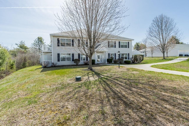 colonial home with a front lawn