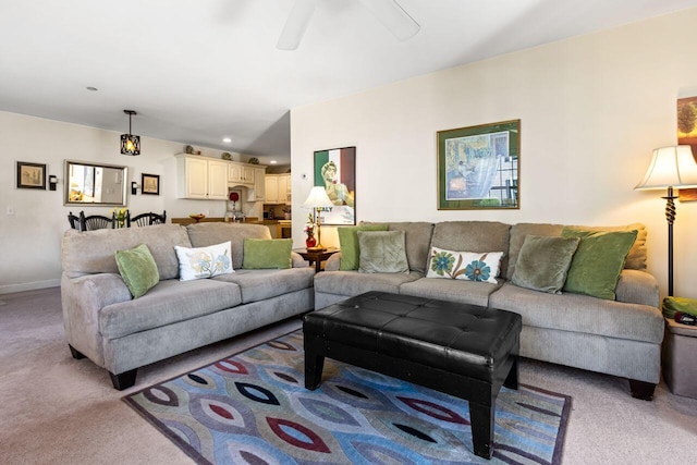 living room with light colored carpet, a ceiling fan, baseboards, and recessed lighting