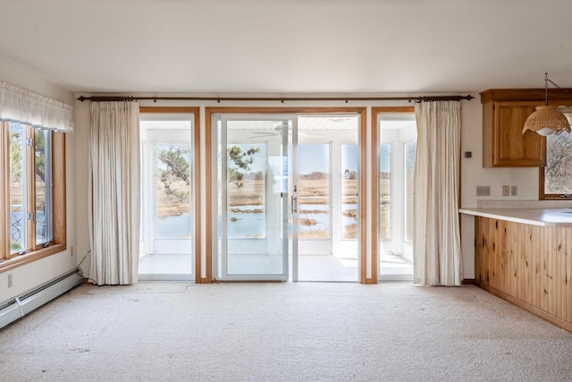 unfurnished living room with light colored carpet and baseboard heating