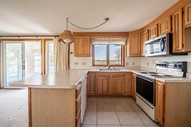kitchen with light countertops, light tile patterned floors, a sink, white appliances, and a peninsula
