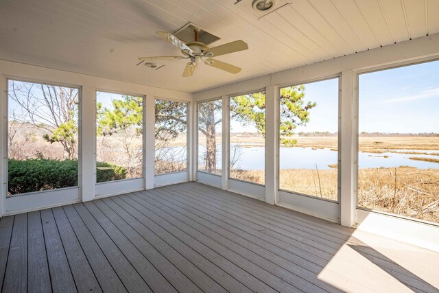 unfurnished sunroom featuring a wealth of natural light and a ceiling fan