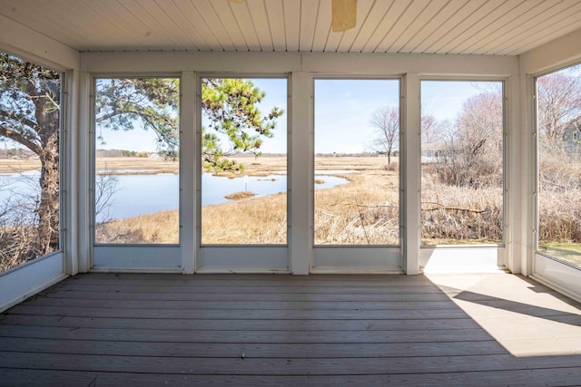 unfurnished sunroom with a water view