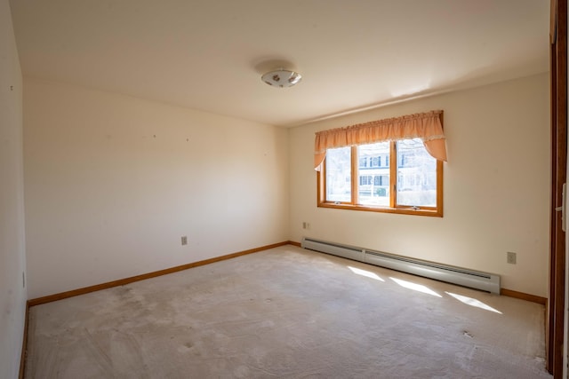 carpeted spare room with baseboards and a baseboard radiator
