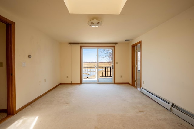 empty room with a baseboard heating unit, baseboards, visible vents, and light colored carpet