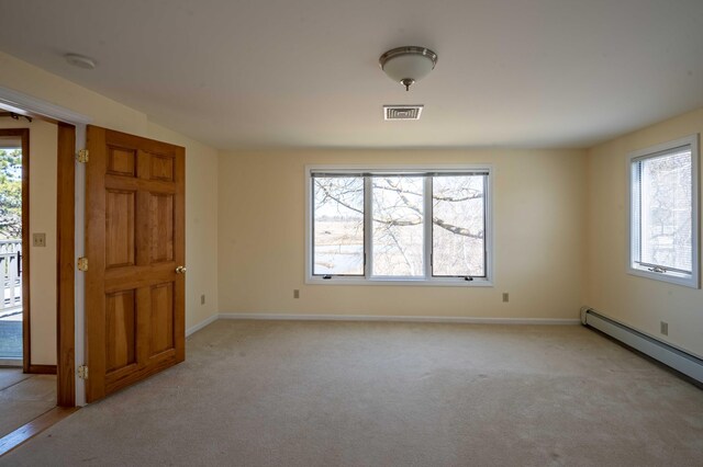 empty room featuring light carpet, baseboards, visible vents, and a baseboard radiator