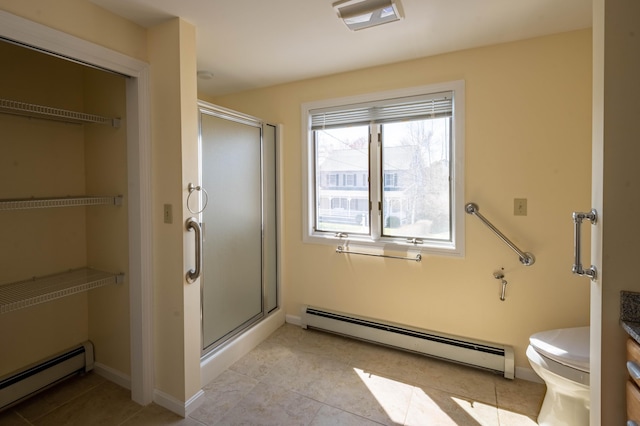 full bath with tile patterned flooring, a shower stall, a baseboard radiator, and toilet