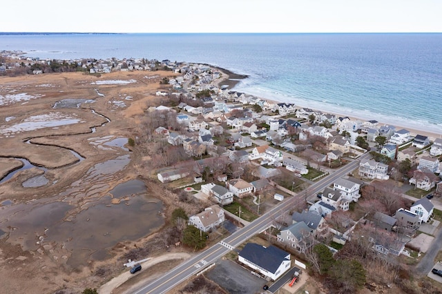 drone / aerial view featuring a beach view, a residential view, and a water view