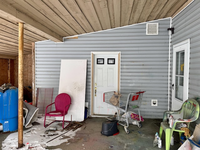 property entrance featuring visible vents and a patio