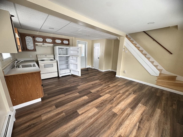 kitchen featuring white electric stove, a baseboard heating unit, a sink, dark wood finished floors, and under cabinet range hood