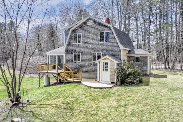 46 Winslow Hill Rd, Nobleboro, ME 04555 - rear view of house with roof with shingles, a chimney, a lawn, a gambrel roof, and a deck