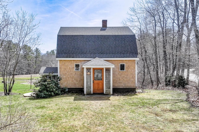 46 Winslow Hill Rd, Nobleboro, ME 04555 - view of front of house featuring a gambrel roof, a chimney, a shingled roof, a front lawn, and an outdoor structure