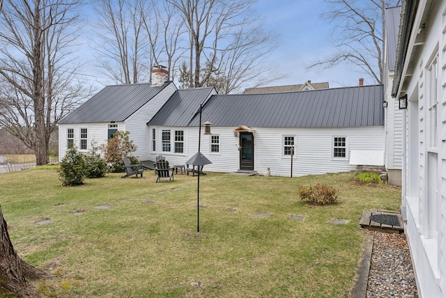 37 Main St, Raymond, ME 04071 - rear view of property featuring a lawn, a chimney, and metal roof