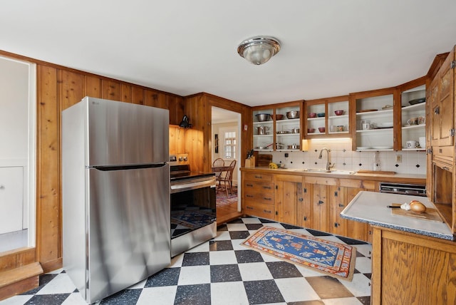 37 Main St, Raymond, ME 04071 - kitchen featuring appliances with stainless steel finishes, tasteful backsplash, wood walls, a sink, and dark floors