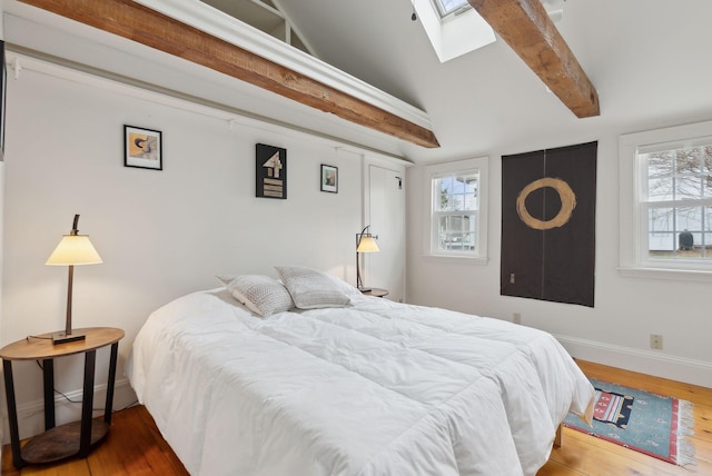 37 Main St, Raymond, ME 04071 - bedroom featuring beamed ceiling, a skylight, multiple windows, and wood finished floors