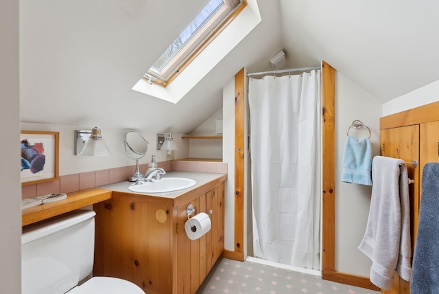 37 Main St, Raymond, ME 04071 - full bath with vaulted ceiling with skylight, vanity, toilet, and a shower with shower curtain