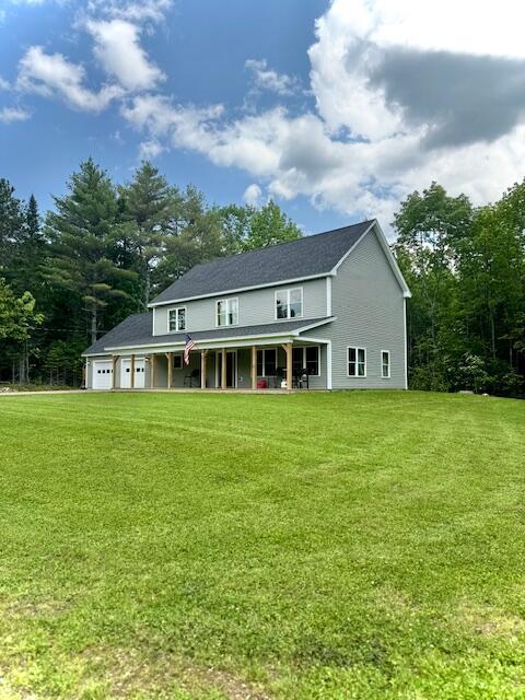 28 Star Gazing Way, China, ME 04358 - back of property with a porch, a lawn, and an attached garage