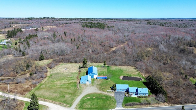 view of property location with a forest