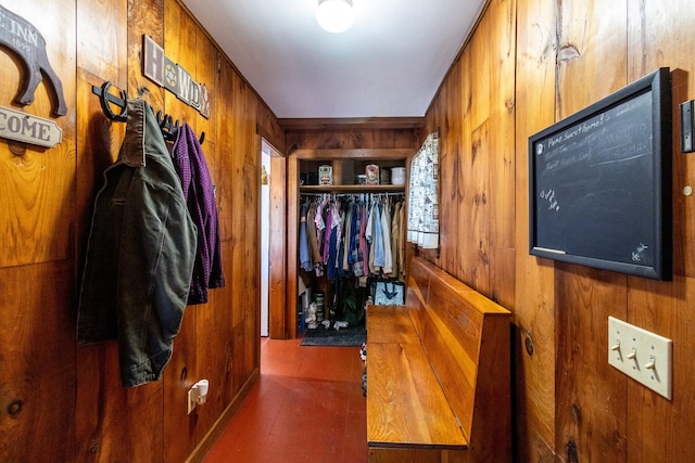 mudroom with wood walls