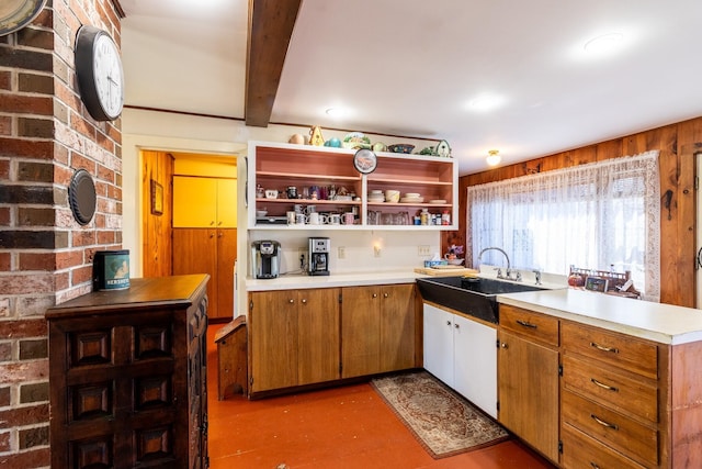 kitchen featuring open shelves, a sink, light countertops, beamed ceiling, and brown cabinets